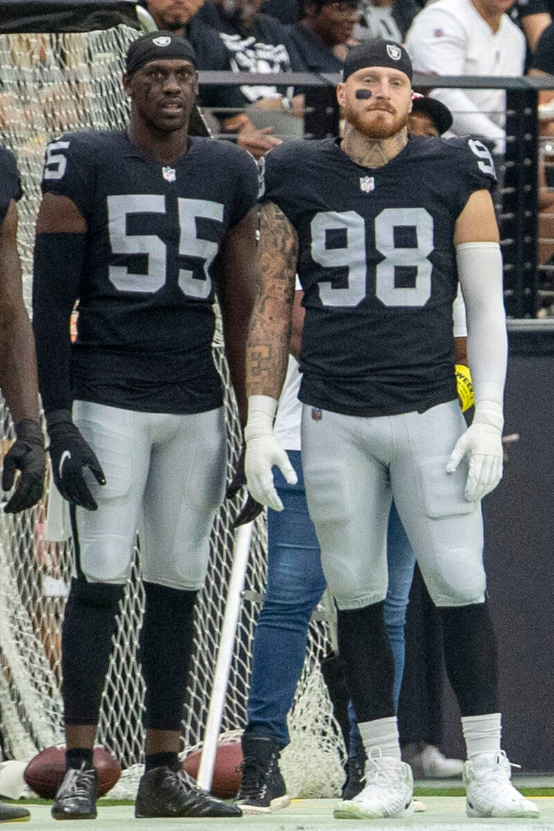 Raiders defensive ends Chandler Jones (55) and Maxx Crosby (98) look on from the sidelines duri ...