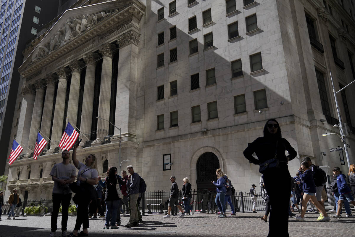 Visitors to the financial district walk past the New York Stock Exchange, Friday, Sept. 23, 202 ...