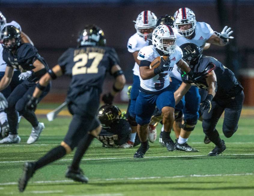 Liberty's running back Isaiah Lauofo (3) breaks free on the Faith Lutheran defense during the f ...