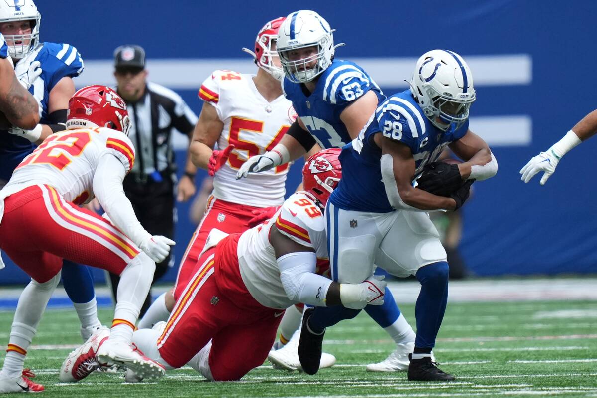 Indianapolis Colts running back Jonathan Taylor (28) is tackled by Kansas City Chiefs defensive ...
