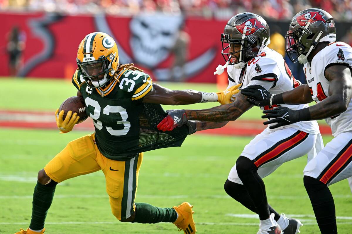 Tampa Bay Buccaneers' Carlton Davis III and Lavonte David try to stop Green Bay Packers' Aaron ...