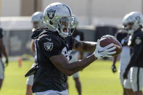 Raiders running back Josh Jacobs (28) makes a catch during the team’s training camp prac ...