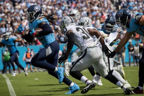 Tennessee Titans running back Derrick Henry (22) breaks into the open field past Raiders safety ...
