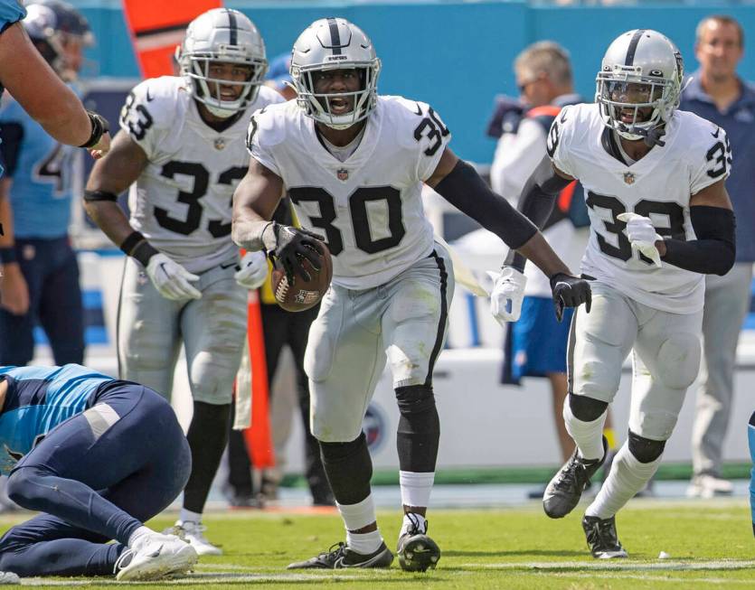 Raiders safety Duron Harmon (30) celebrates his interception with safety Roderic Teamer (33) an ...