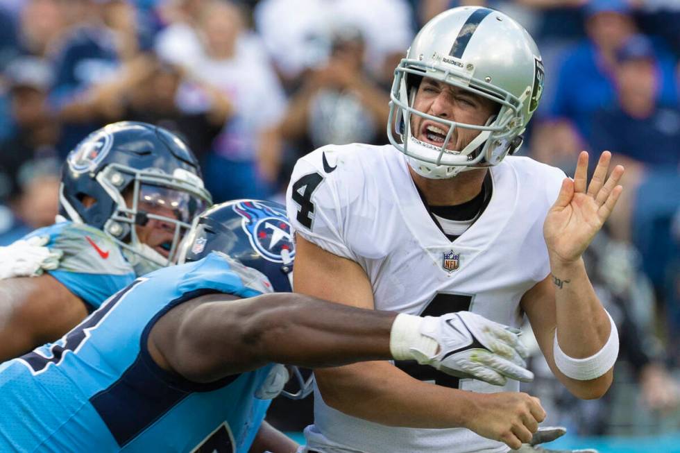 Raiders quarterback Derek Carr (4) is hit by Tennessee Titans defensive tackle Jeffery Simmons ...
