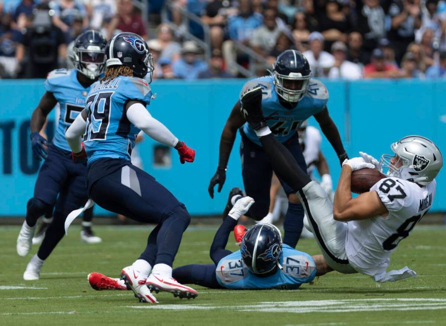 Raiders tight end Foster Moreau (87) is up ended by Tennessee Titans safety Amani Hooker (37) d ...