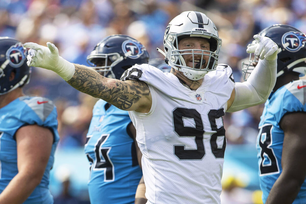 Raiders defensive end Maxx Crosby (98) signals after the Tennessee Titans were penalized during ...