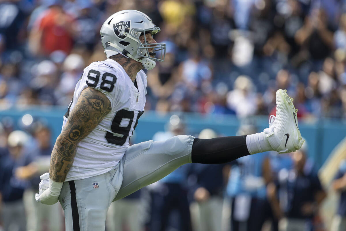 Raiders defensive end Maxx Crosby (98) celebrates a tackle for loss on Tennessee Titans running ...