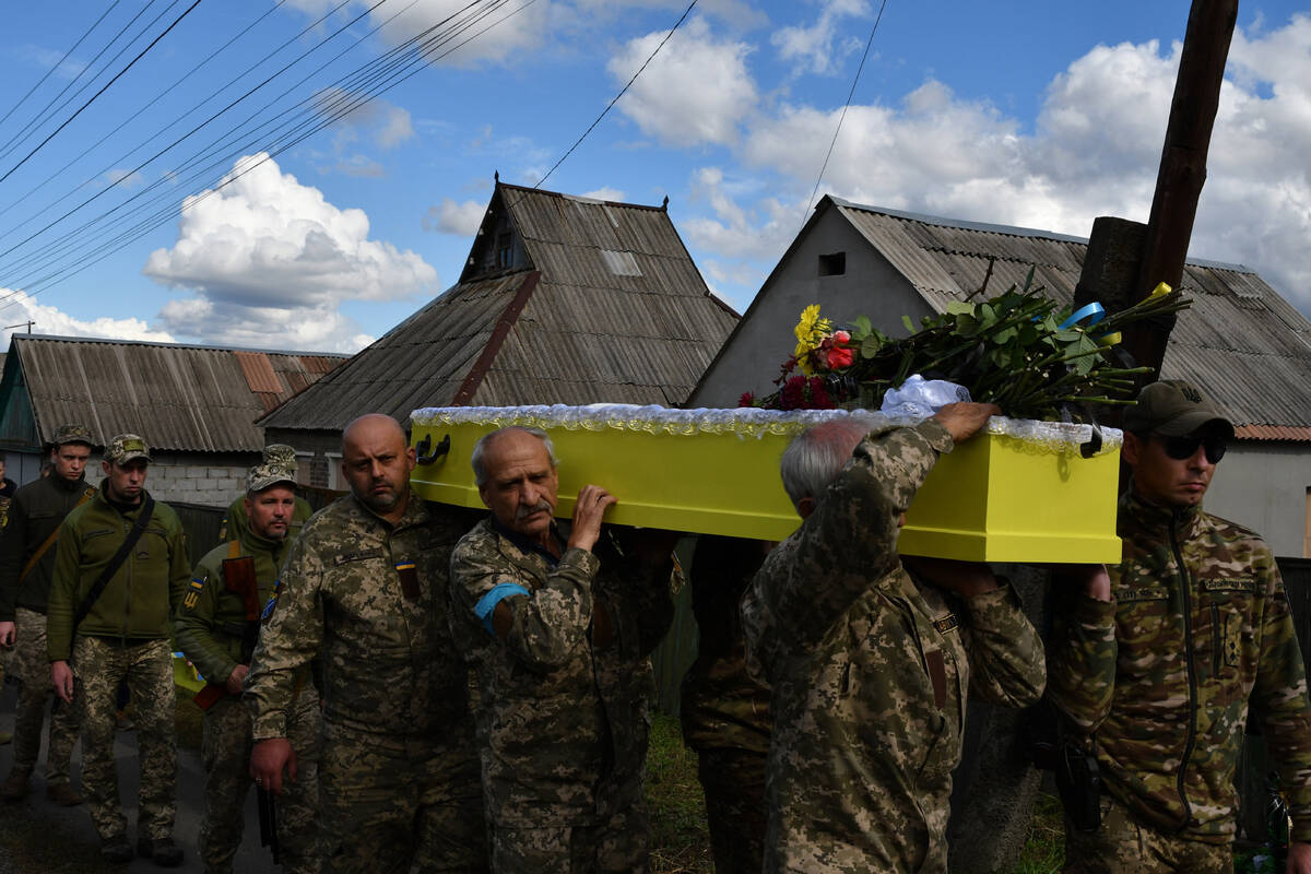 Soldiers carry the coffin of their comrade, Ukrainian military officer Volodumur Linsky, who wa ...