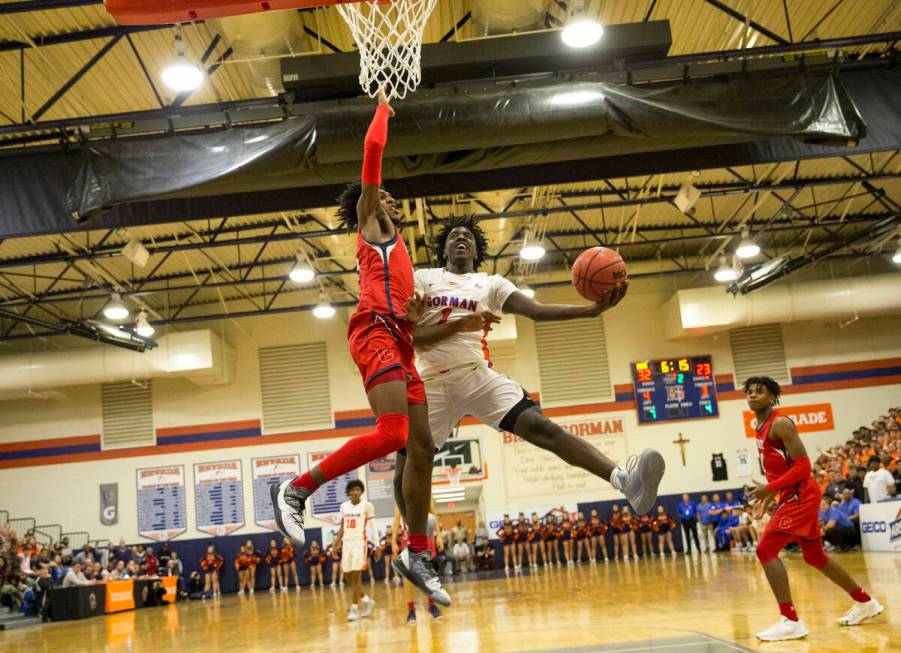 Bishop Gorman's Will McClendon (1) goes up for a shot against Coronado's Felix Reeves (5) durin ...