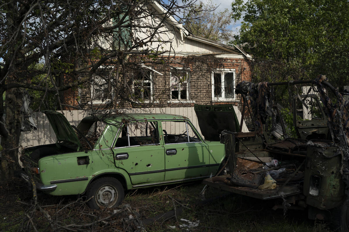 Damaged cars in the retaken village of Shchurove, Ukraine, Sunday, Sept. 25, 2022. (AP Photo/Le ...