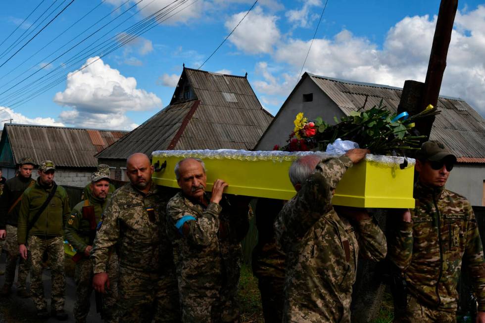 Soldiers carry the coffin of their comrade, Ukrainian military officer Volodumur Linsky, who wa ...