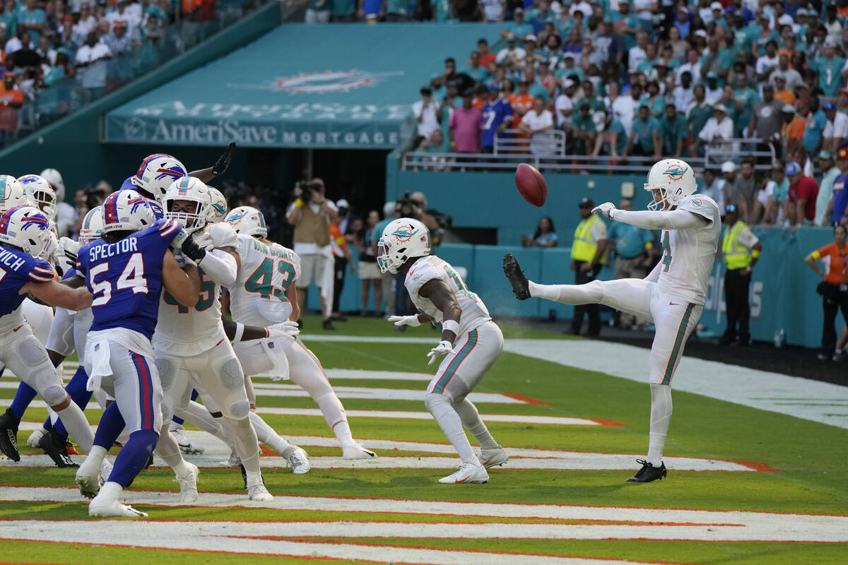 Miami Dolphins punter Thomas Morstead (4) sees the ball go backwards after attempting a punt du ...