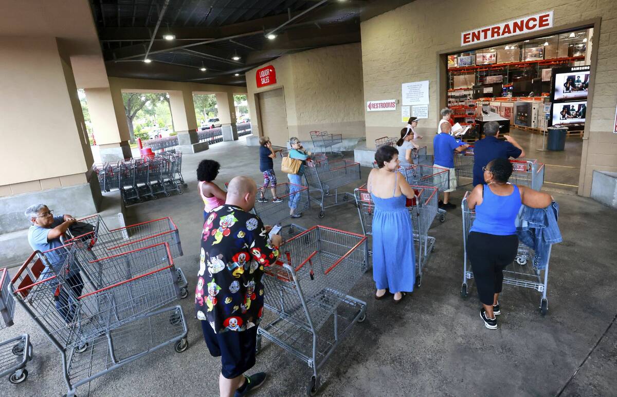 Shoppers wait in line to enter the Costco store in Altamonte Springs, Fla., north of Orlando, M ...