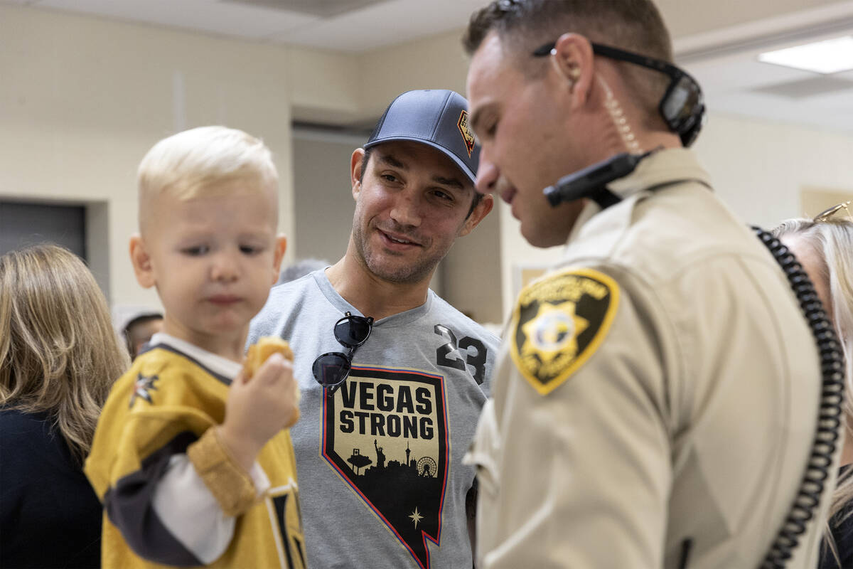 Golden Knights defenseman Alec Martinez meets Beau Moss, 2, and his father Officer Kevin Moss a ...