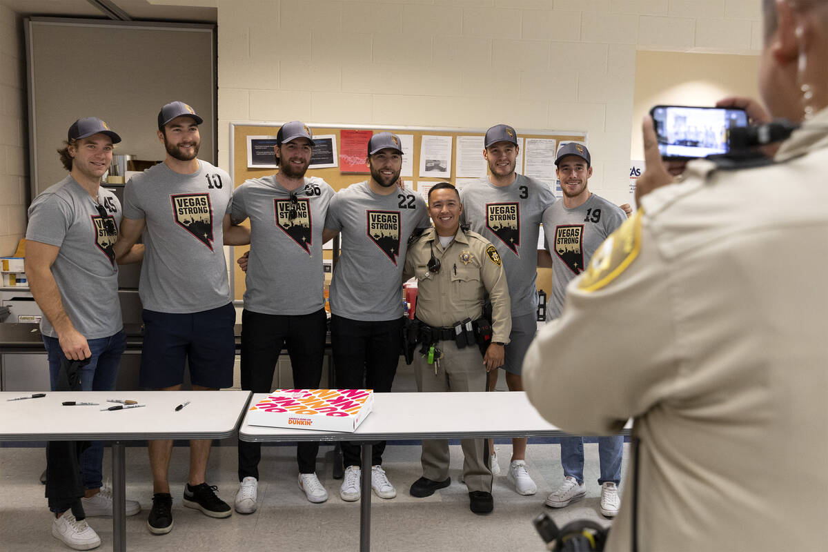 Officer Alexander Mortel poses for a photo with several members of the Vegas Golden Knights at ...
