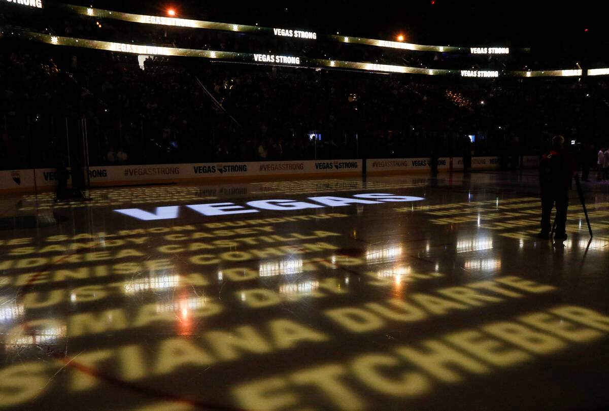 Names of victims in the mass shooting in Las Vegas are displayed on the ice before an NHL hocke ...