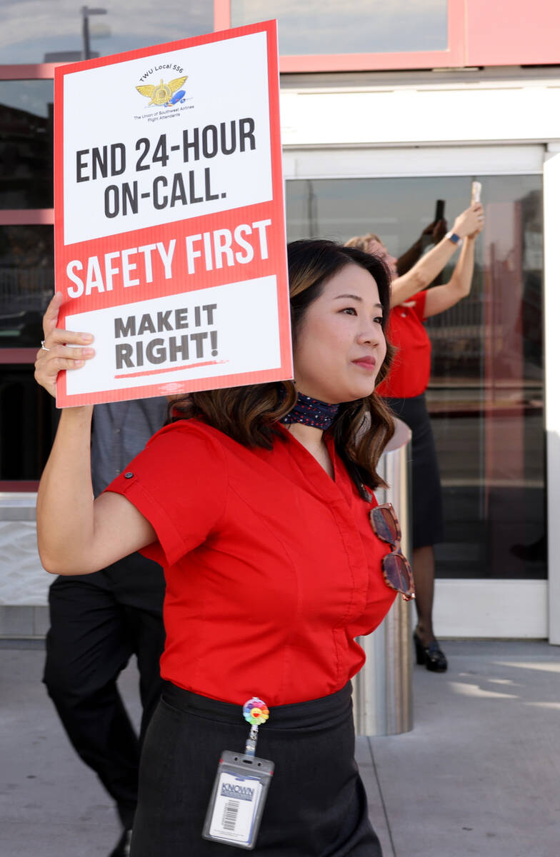 Southwest Airlines flight attendants, including Lisa Leong, picket outside Terminal 1 at Harry ...