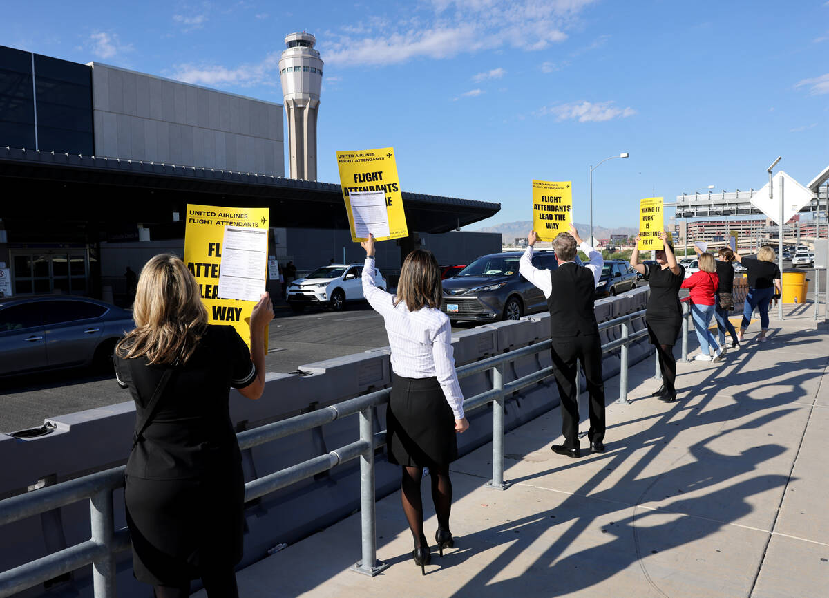 United Airlines flight attendants picket outside Terminal 3 at Harry Reid International Airport ...