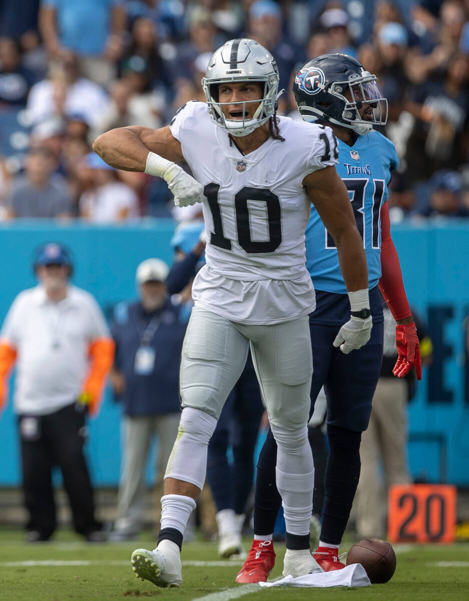 Raiders wide receiver Mack Hollins (10) celebrates a catch over Tennessee Titans safety Kevin B ...