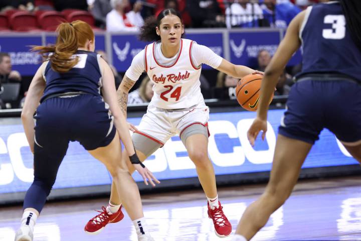 UNLV Lady Rebels guard Essence Booker (24) brings the ball up court under pressure from Utah St ...