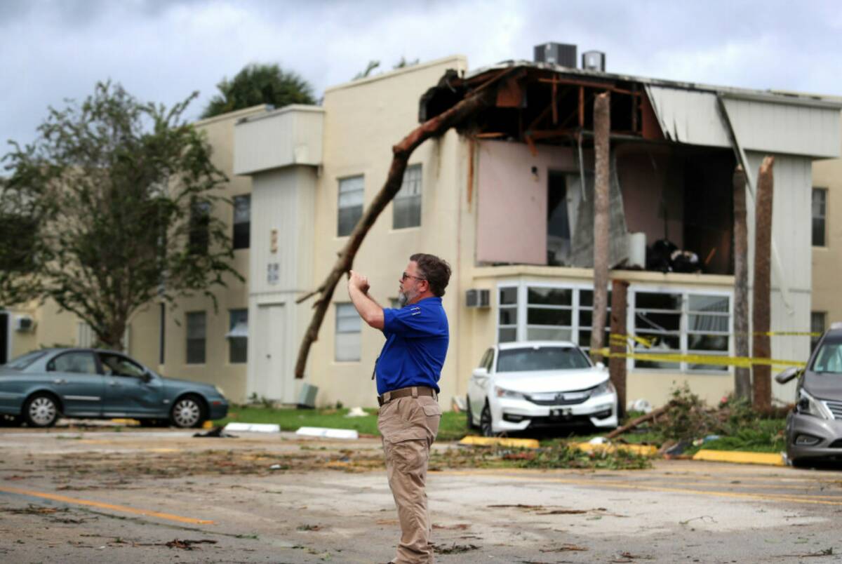 David Dellinger with the National Weather Service, surveys the damage from an apparent overnigh ...