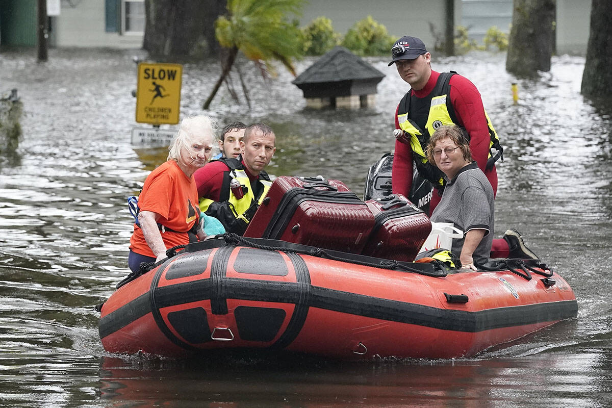 Residents are rescued from floodwaters in the aftermath of Hurricane Ian in Orlando, Fla., on T ...