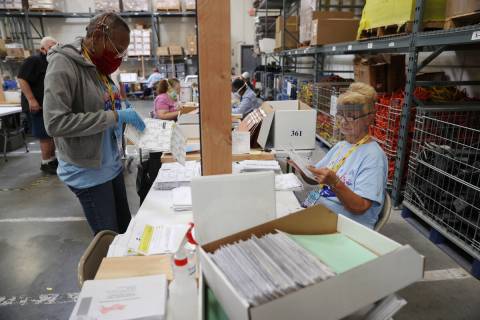 Gale Macon, left, and G. Karen Edwards count ballots at the Clark County Election Department in ...