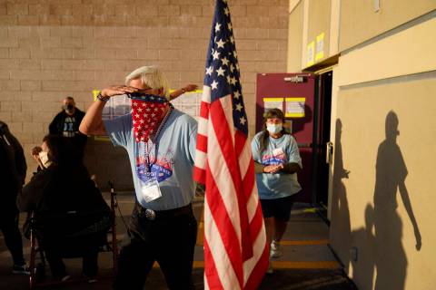 Poll workers prepare to open a polling place on Election Day, Tuesday, Nov. 3, 2020, in Las Veg ...