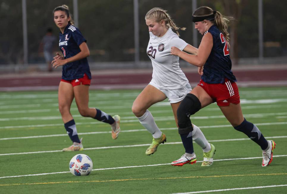 Desert Oasis' Skylar Callaway (20) moves the ball under pressure from Liberty's Madisyn Marches ...