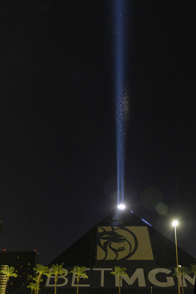 Grasshoppers swarm about the Luxor Sky Beam from atop its pyramid on Thursday, Sept. 29, 2022, ...