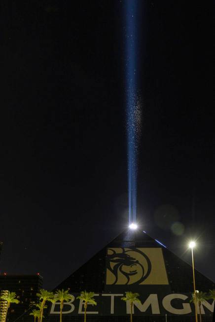 Grasshoppers swarm about the Luxor Sky Beam from atop its pyramid on Thursday, Sept. 29, 2022, ...