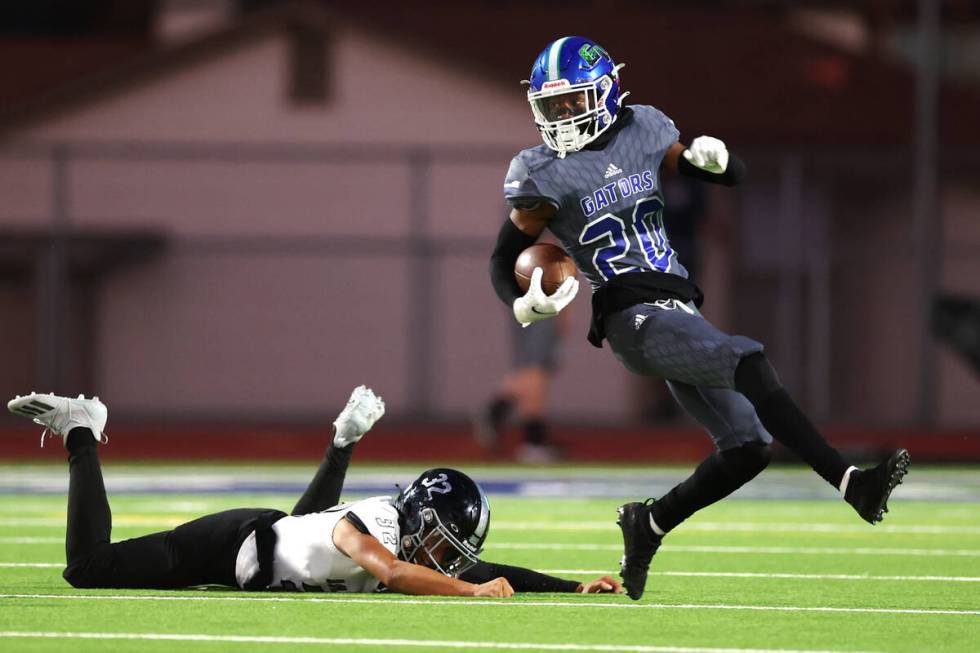 Desert Pines' Isaiah Rubin (20) avoids a tackle against Green Valley in the first half of a foo ...