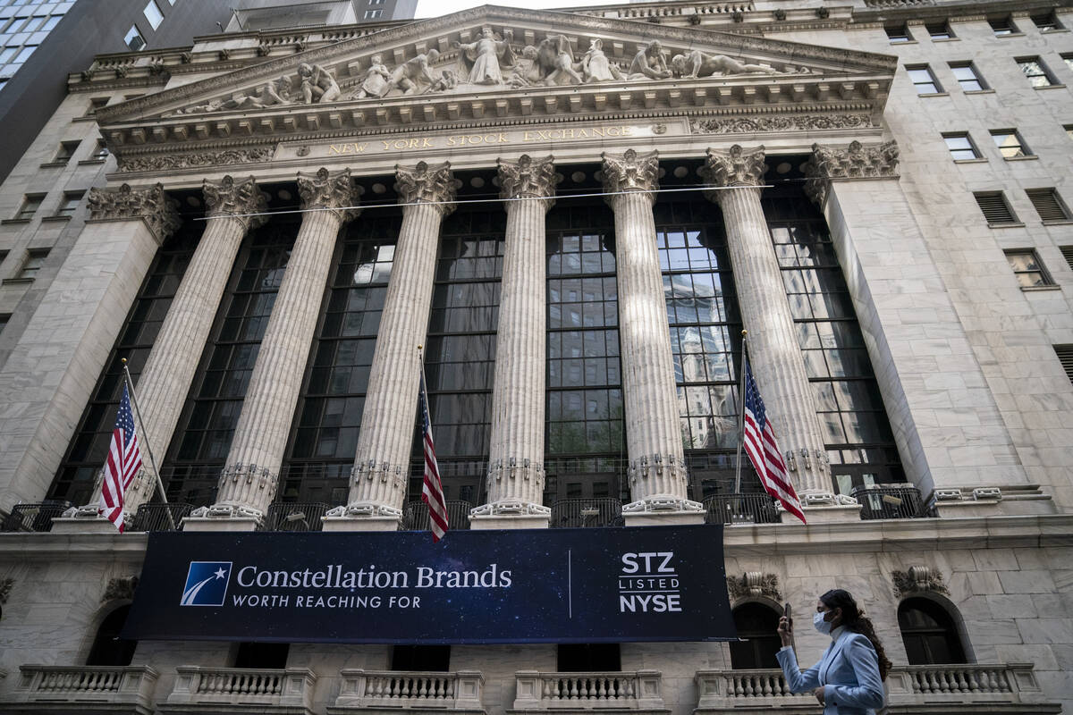 FILE - Pedestrians pass the New York Stock Exchange, Thursday, May 5, 2022, in the Manhattan bo ...