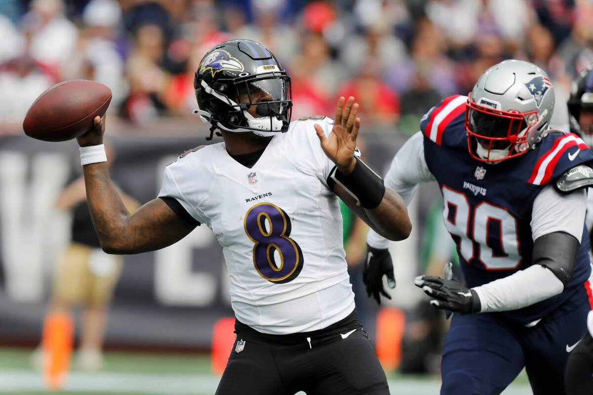 Baltimore Ravens quarterback Lamar Jackson (8) plays against the New England Patriots in the fi ...