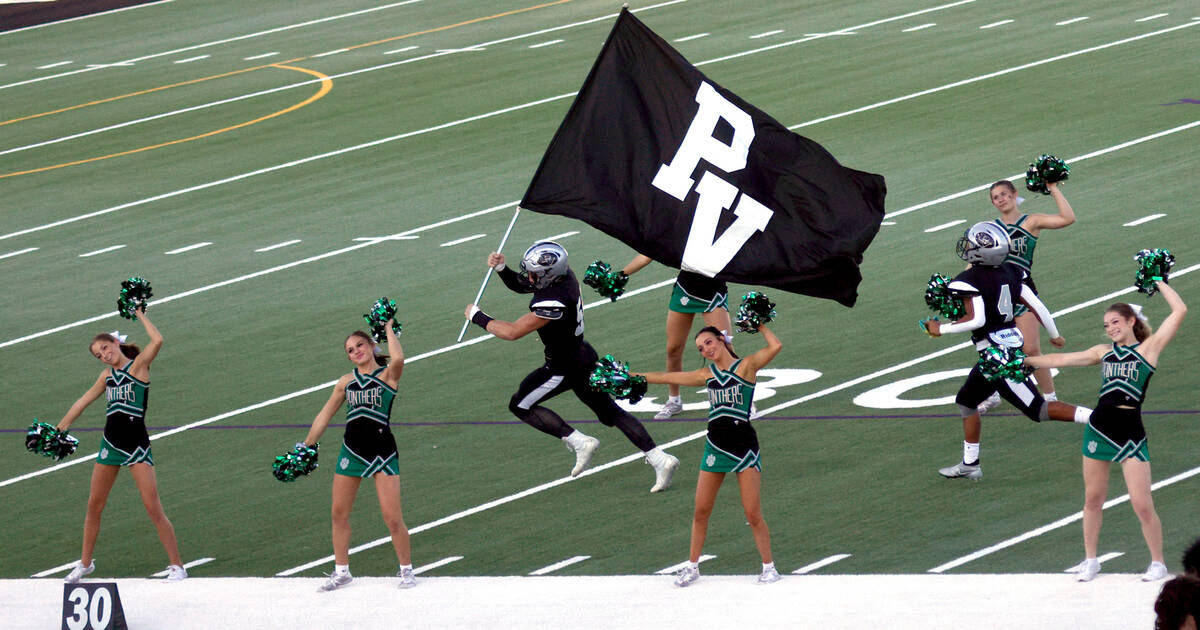 Palo Verde’s Dustin Kane, center, runs out to the field with holding a flag before a foo ...