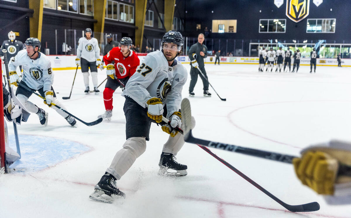 Golden Knights defenseman Shea Theodore (27) eyes the puck movement during practice at City Nat ...