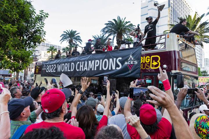 Fans watch as the Las Vegas Aces pass by during the team's WNBA Championship victory parade on ...