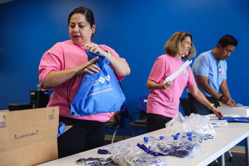 Paola Luzi, assistant for Anthem Nevada Medicaid, from left, works with Lynette Mason, plan per ...