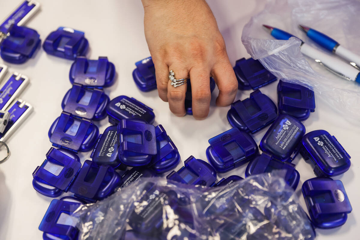 Paola Luzi, assistant for Anthem Nevada Medicaid, packs a gift bag for the Mammo-Rama Extravaga ...