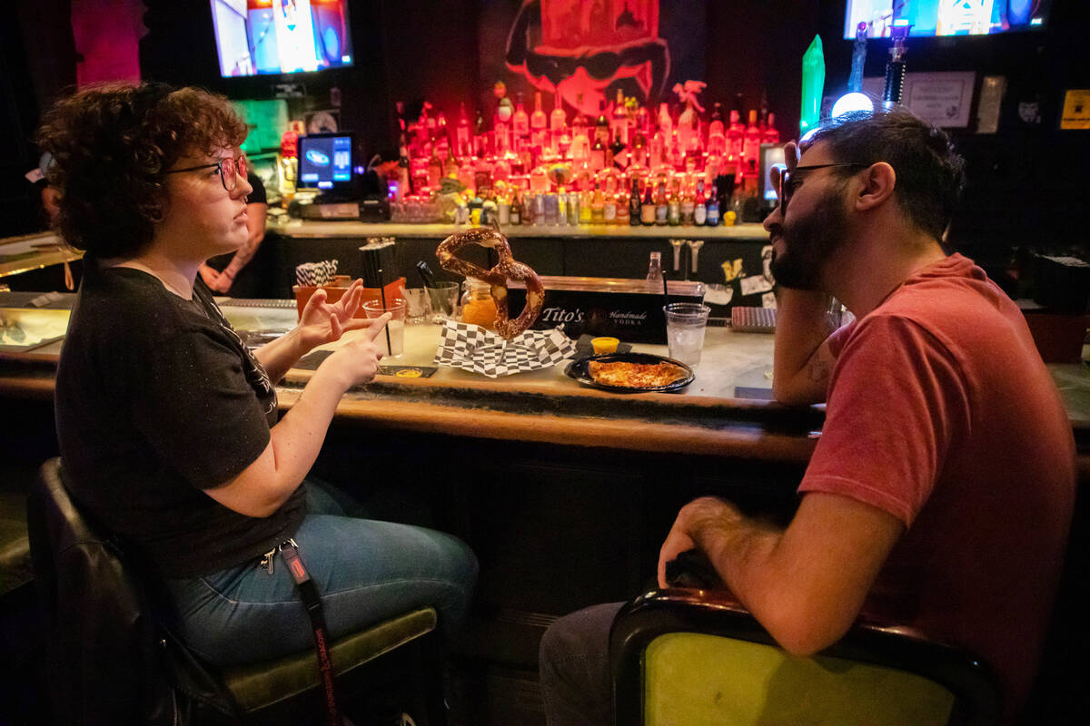 Eleanor Murphy, left, and Miguel Rivera enjoy food and drinks at the Millenium Fandom Bar on We ...