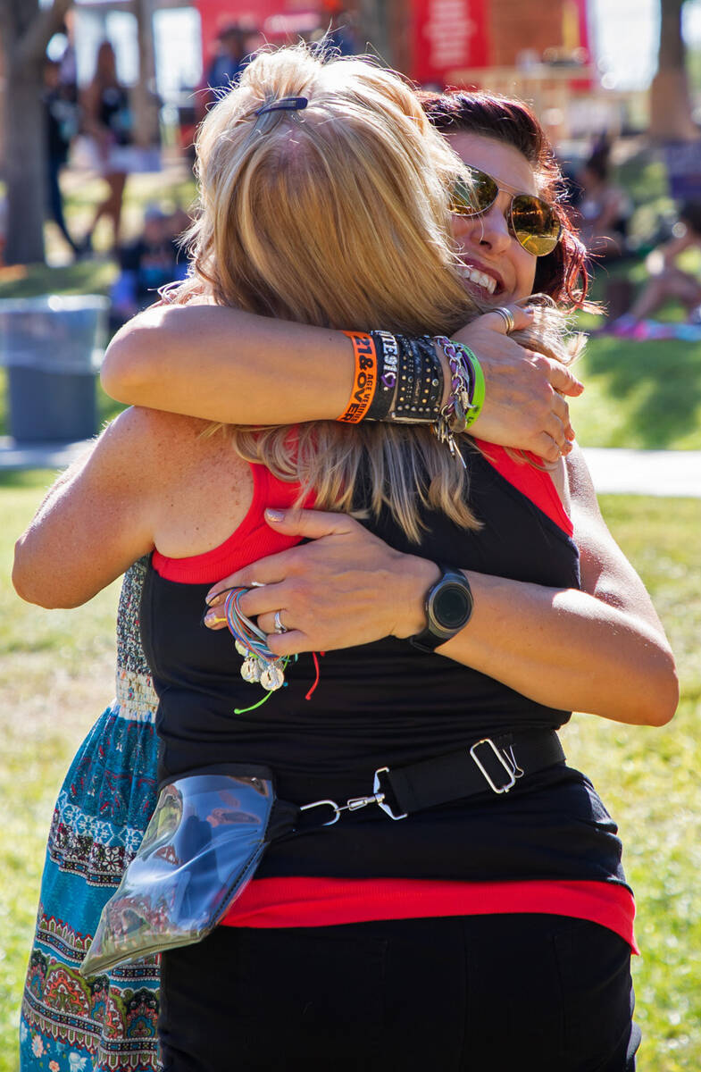 Jessica Paul, facing, hugs a friend during the Remember Music Festival on Saturday, Oct. 1, 202 ...