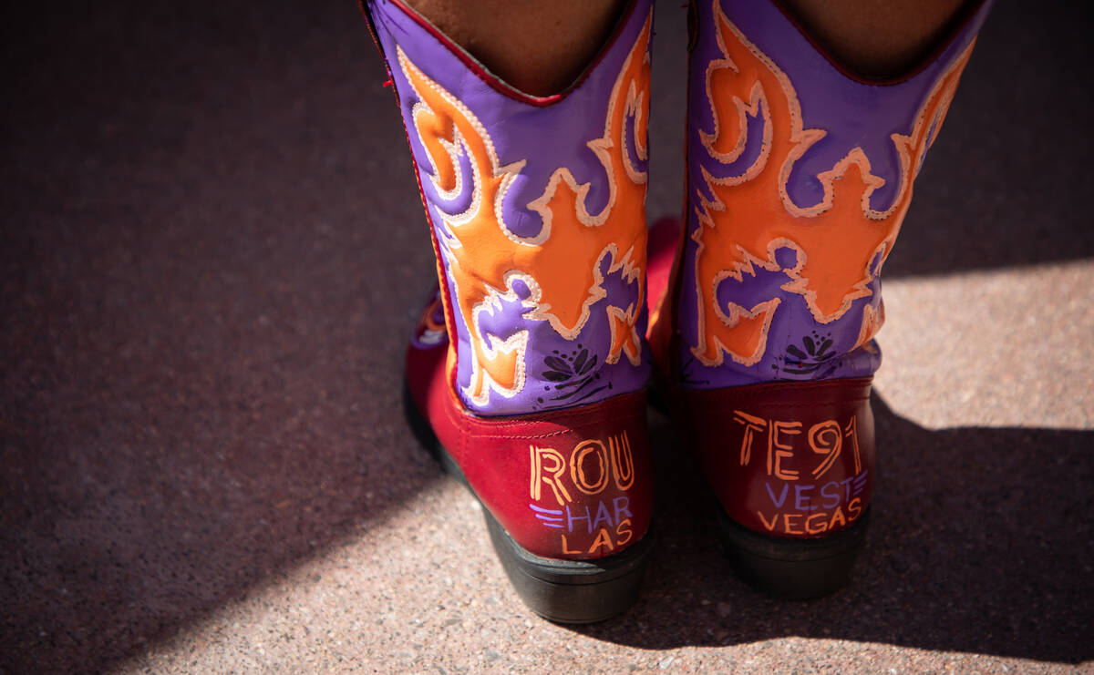 Becky Elzinga, 66, shows off her cowboy boots at the Remember Music Festival on Saturday, Oct. ...