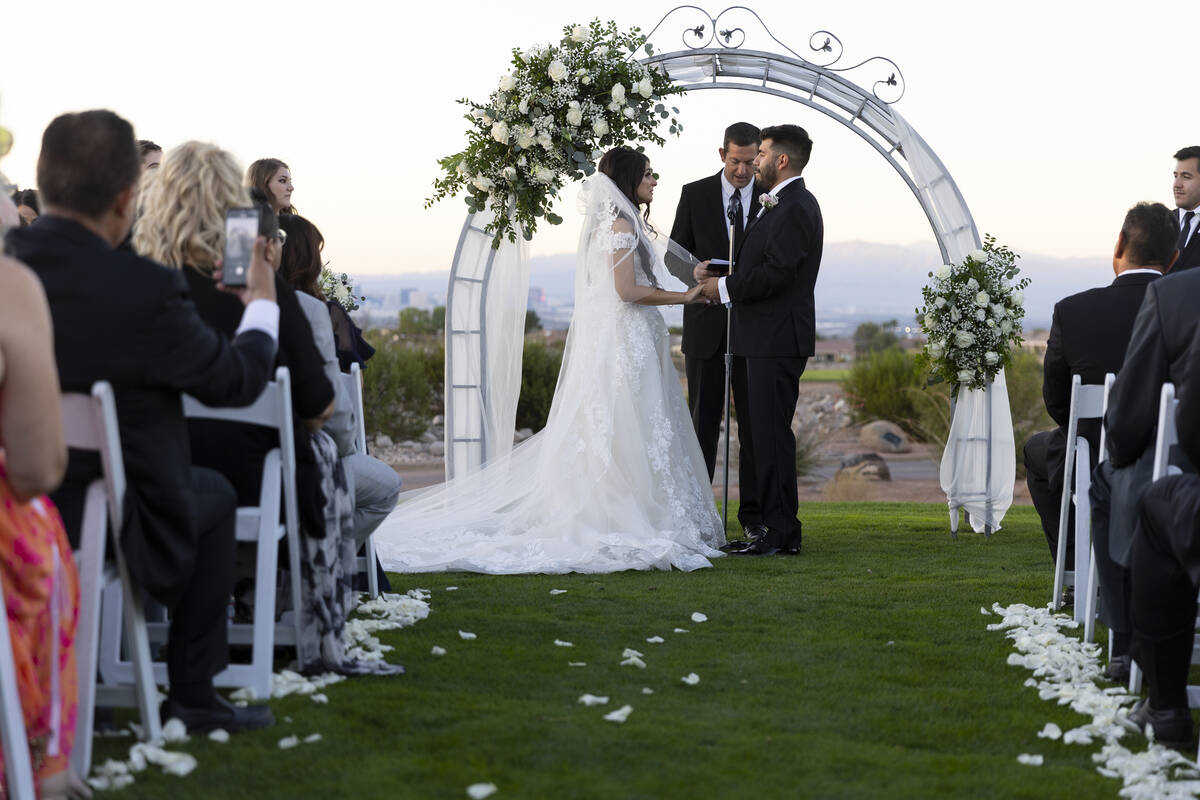 Brittany Castrejon, left, marries her fiancé, Jorge Gonzalez-Calvillo, during their weddin ...
