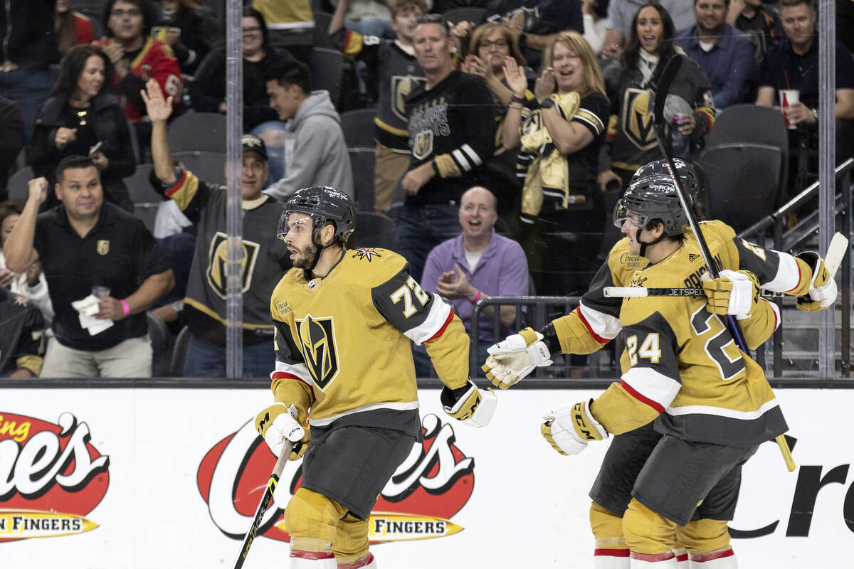 Fans cheer for Golden Knights forward Gage Quinney (72) while he skates off the ice after he sc ...