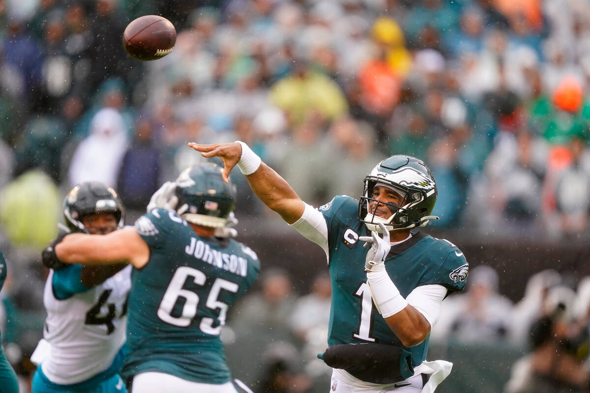 Philadelphia Eagles' Jalen Hurts passes during the first half of an NFL football game against t ...