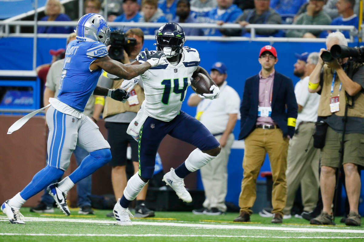 Seattle Seahawks wide receiver DK Metcalf (14) pushes off Detroit Lions safety DeShon Elliott ( ...