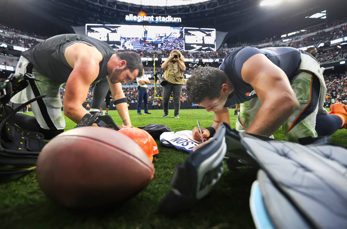 Raiders quarterback Derek Carr and Denver Broncos quarterback Russell Wilson trade jerseys afte ...