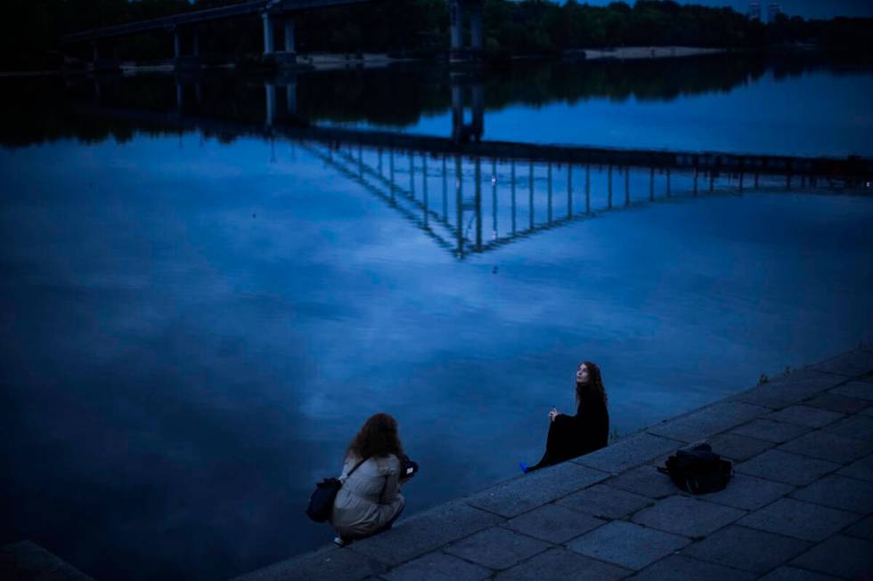 A woman poses for a photo session at the Dnipro riverbank in Kyiv, Ukraine, Saturday, Oct. 1, 2 ...