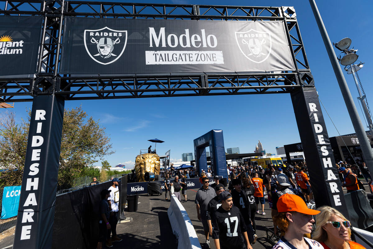 Football fans explore the Modelo tailgate zone before the start of an NFL game between the Raid ...